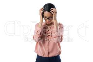 Tensed female executive standing against white background