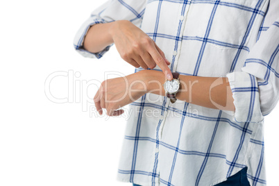 Female executive pointing at the wristwatch