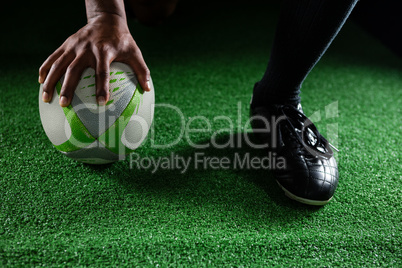 Close up of sportsman holding rugby ball