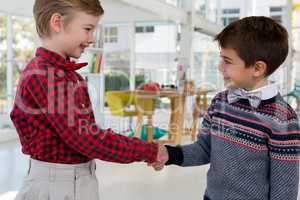Kids as business executives shaking hands