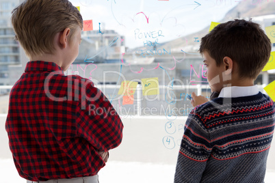 Kids as business executives discussing over whiteboard