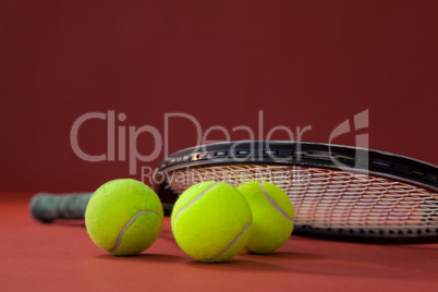 Close up of tennis racket on balls