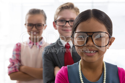 Kids as business executive smiling while standing in the office