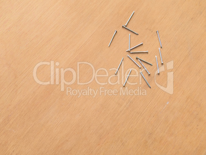 Several new nails on wooden background board