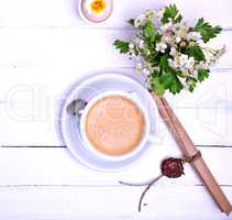 Cup of coffee on a white wooden background