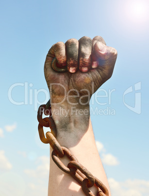 man's hand is encased in an iron rusty chain