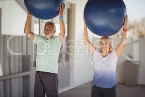 Senior couple exercising with exercise ball