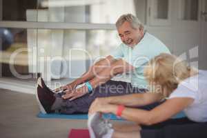Senior couple performing stretching exercise