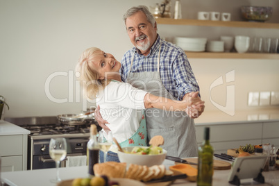 Senior couple dancing in kitchen