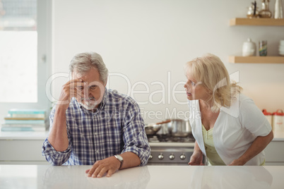 Senior couple arguing in kitchen