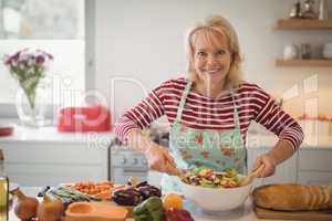 Senior woman preparing meal in kitchen