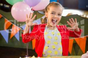 Portrait of excited girl in birthday party