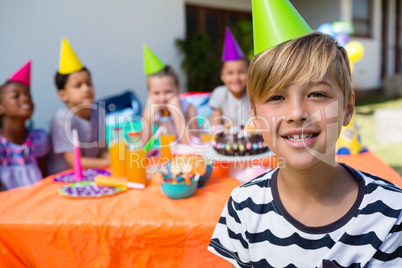 Portrait of boy with friends in background