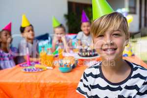 Portrait of boy with friends in background