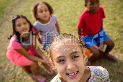 High angle view of children sitting in yard