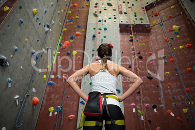 Woman standing with hands on hip in fitness studio