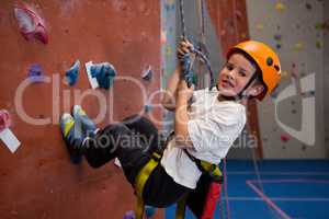 Portrait of determined boy practicing rock climbing