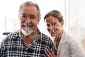 Smiling female doctor with senior patient in nursing home