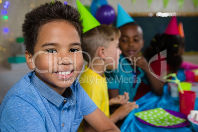 Portrait of boy sitting with friends