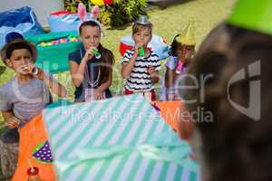 Children blowing party horn