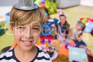 Close up portrait of happy boy with friends in background