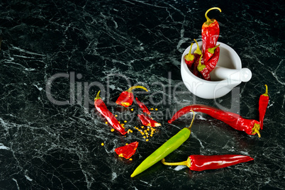 Red Hot Chili Peppers in mortar over dark background