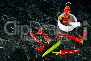 Red Hot Chili Peppers in mortar over dark background