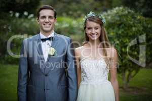 Wedding couple standing together in garden