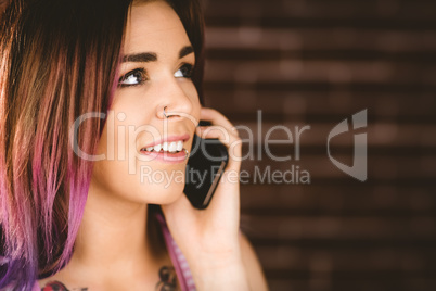 Smiling woman talking on mobile phone