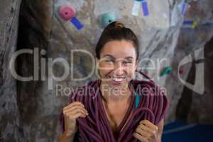 Happy woman with rope in fitness studio