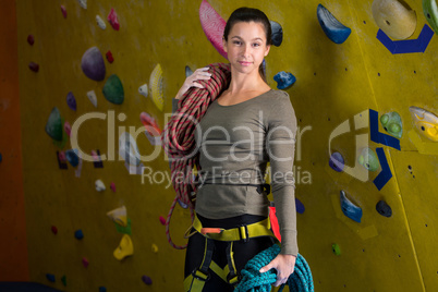 Happy woman with rope in fitness studio