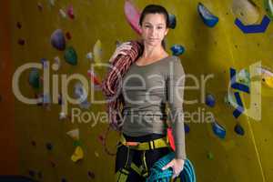 Happy woman with rope in fitness studio