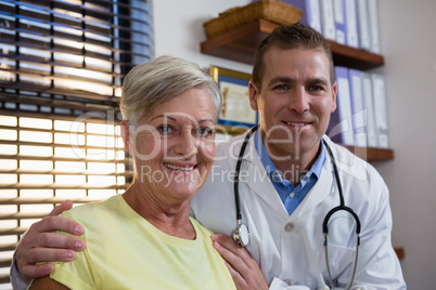 Smiling senior woman and physiotherapist in clinic