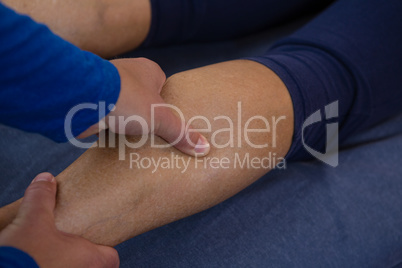 Physiotherapist giving leg massage to a woman