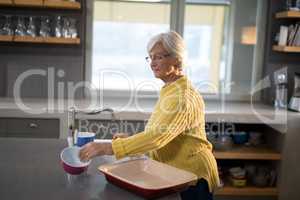 Senior women picking up a bowl