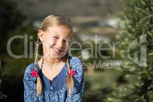 Girl smiling at camera on a sunny day