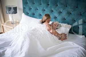 Granddaughter talking to grandmother on bed