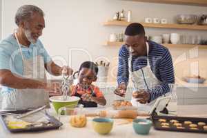 Boy learning to whisk the eggs while preparing cookies