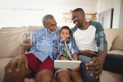 Multi-generation family using digital tablet in living room