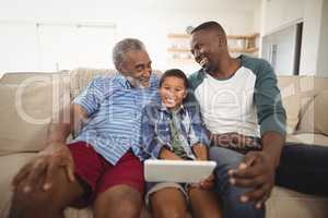 Multi-generation family using digital tablet in living room