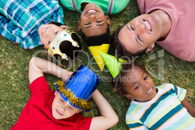 Directly above shot of man with children lying on field