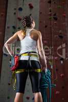 Woman standing with hands on hip in fitness studio