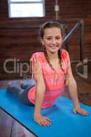 Portrait of happy teenage girl practicing yoga