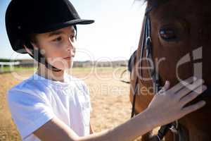Girl caressing the white horse in the ranch
