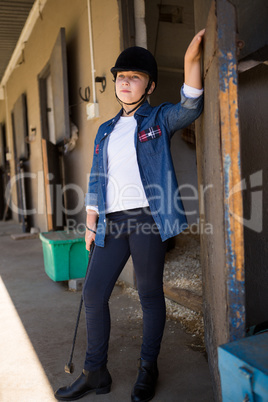 Girl standing in the stable