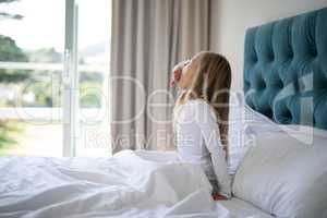Girl yawning while waking up n bed