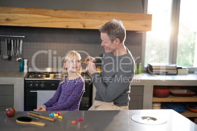 Father brushing daughters hair