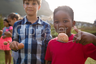 Portrait of boys playing egg and spoon race
