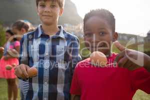 Portrait of boys playing egg and spoon race