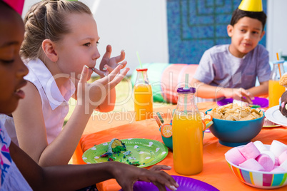 Children having food at table